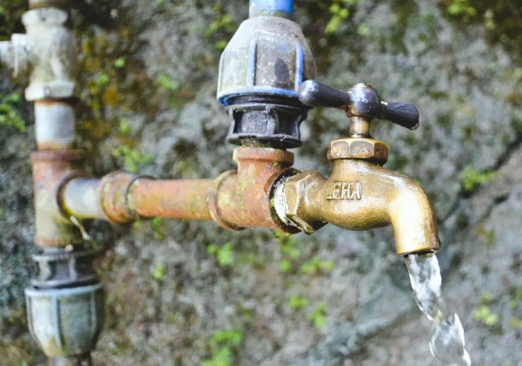 Water faucet representing daily household water use and consumption