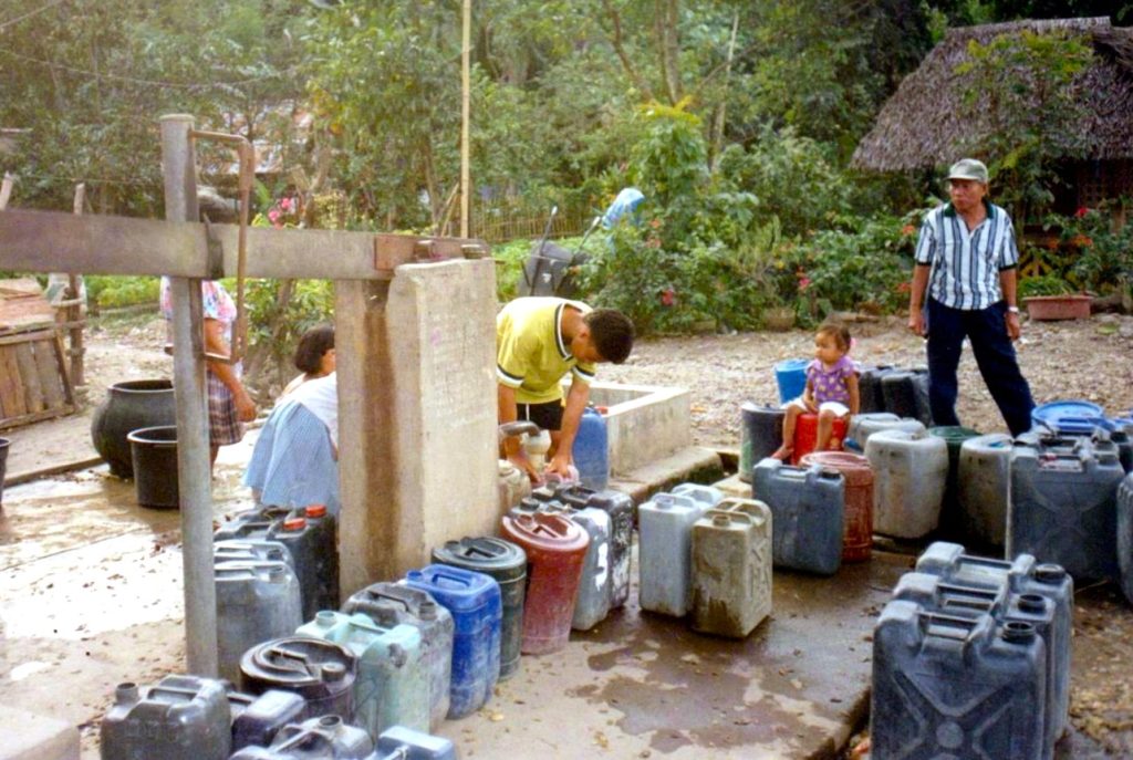 Residents collect water in containers as communities face daily struggles caused by the water crisis in the Philippines.