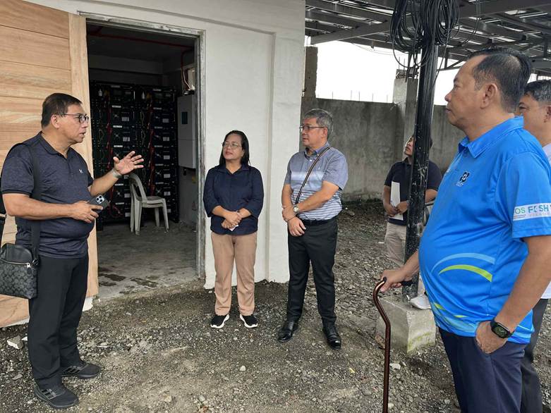 renewable energy for businesses as officials inspect solar power installation at a commercial site