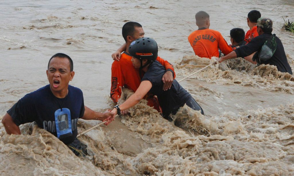 Emergency responders rescuing flood victims during disaster response operations