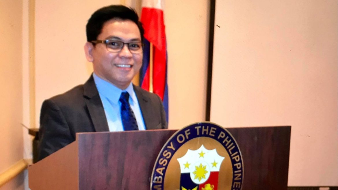 Atty. Nicolas M. Caraquel delivering a speech at a Filipino community and immigration-related event.