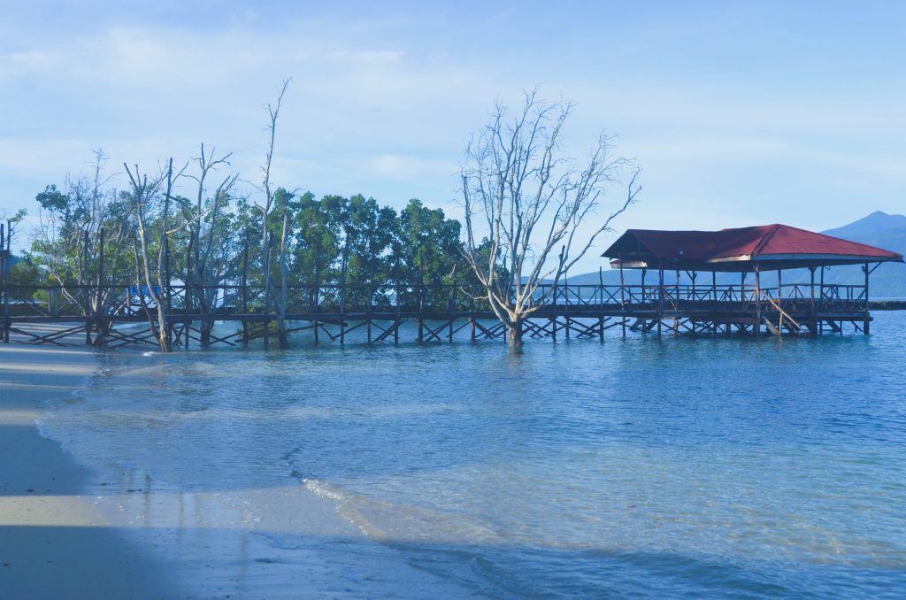 Bahia Beach Resort in Mati City featuring calm waters and coastal cottages.