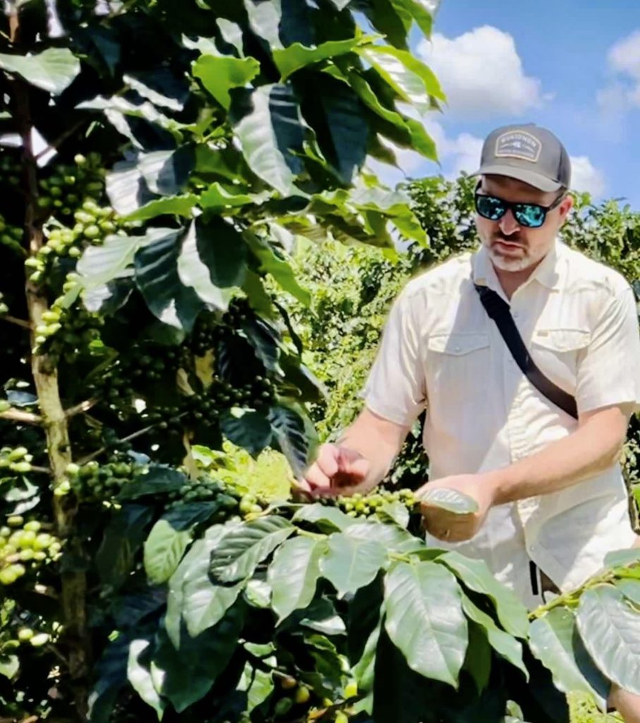 Casey Burnett with a local coffee farmer supporting a coffee project helping abandoned children in the Philippines