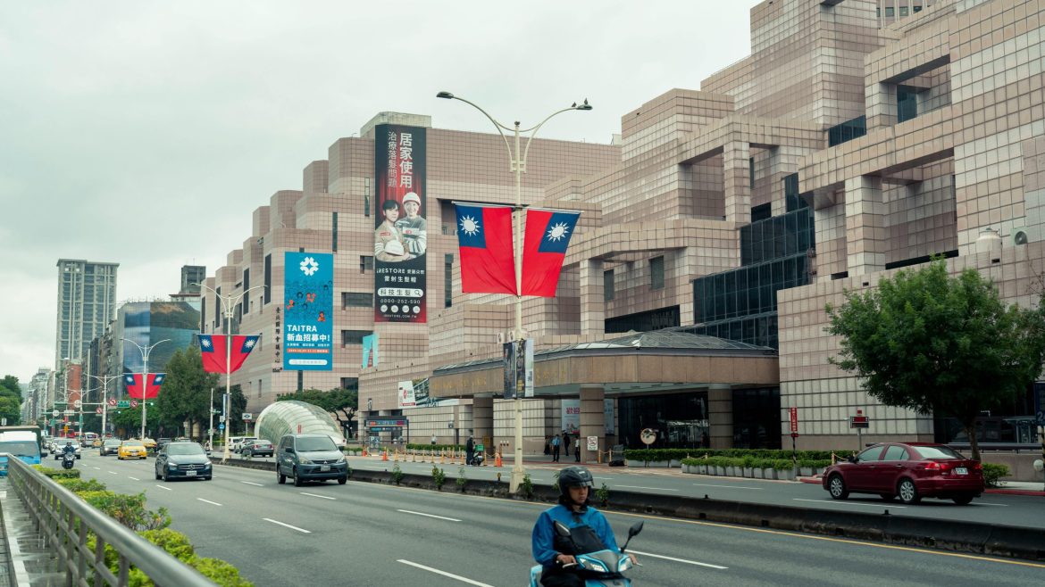 Street view in Taipei City showing buildings and a Taiwan flag as authorities investigate a national security case