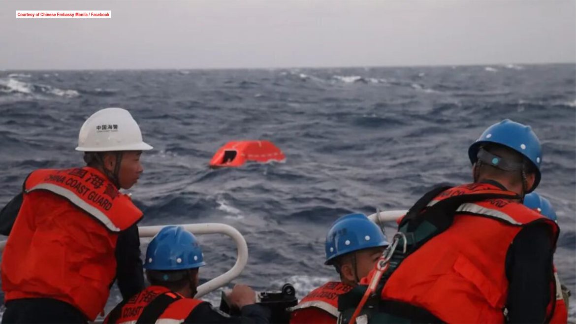 China Coast Guard personnel conduct a rescue operation at sea after a cargo ship capsized, saving Filipino crew members.