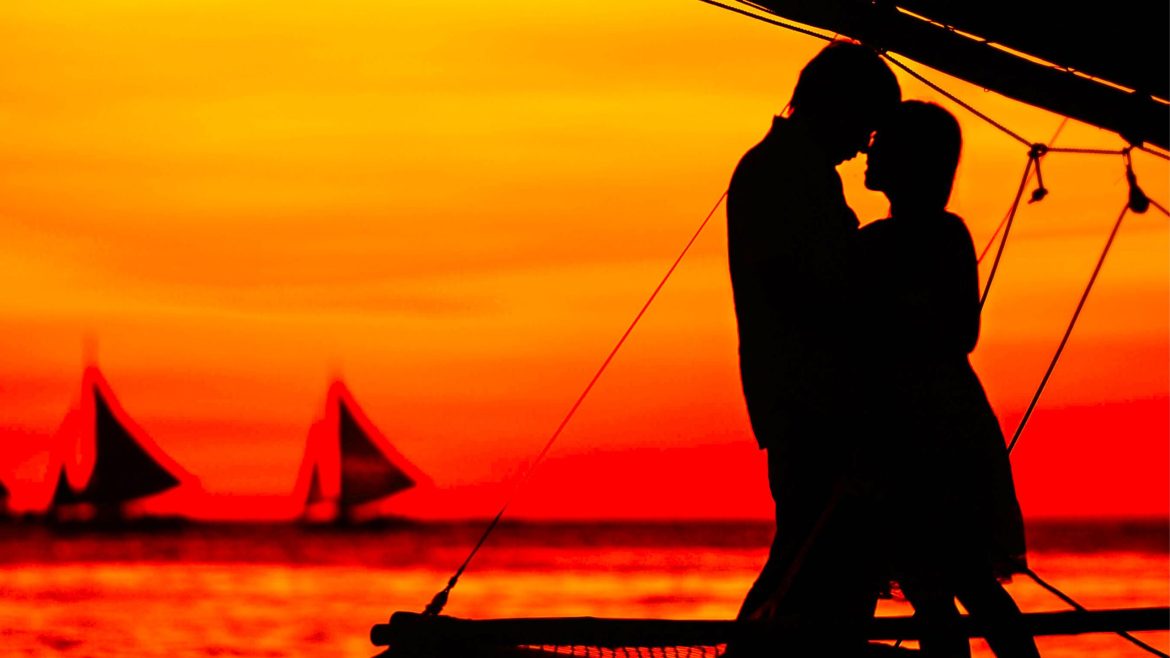 Silhouette of a couple embracing at sunset symbolizing online romance scams and Valentine’s Day fraud risks