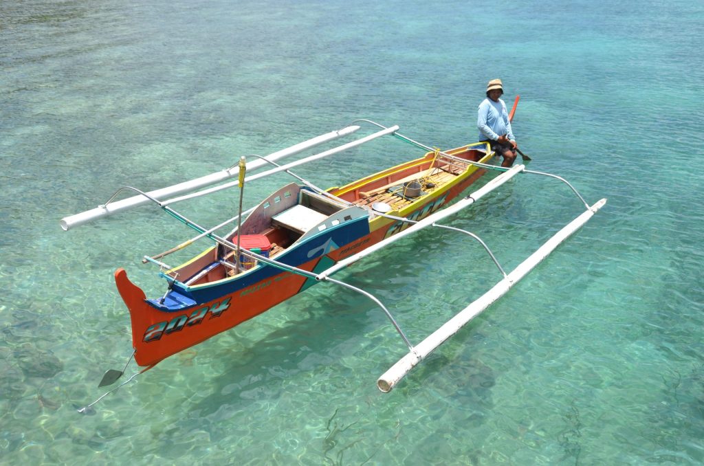 Filipino fisherman fishing in coastal waters affected by climate change