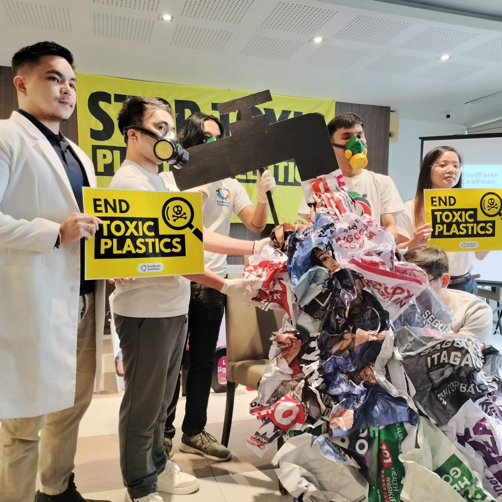 Advocates hold a Stop Toxic Plastic Pollution banner during environmental campaign