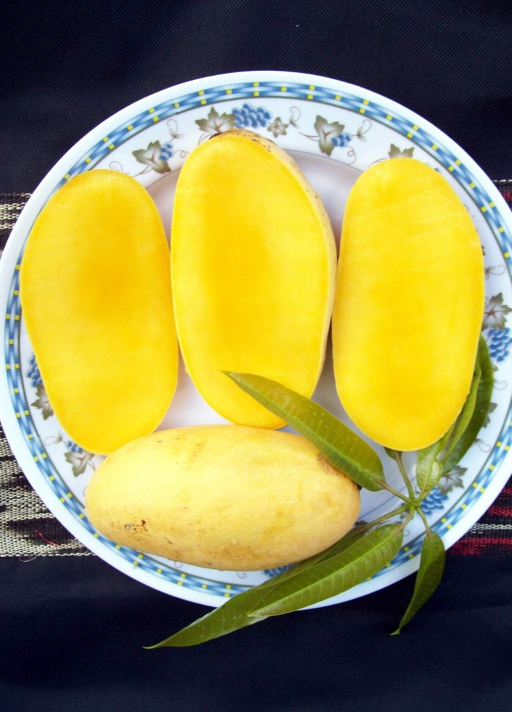 Fresh sliced Philippine Carabao mango on a plate showing its bright yellow flesh
