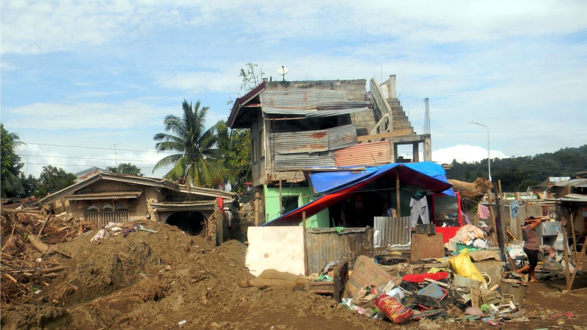 Homes severely damaged and partially collapsed following Typhoon Sendong in the Philippines.