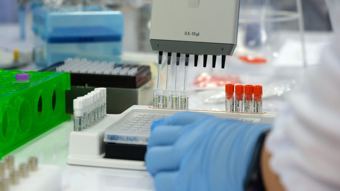 Scientist using pipette in forensic DNA laboratory applying advanced DNA technology in SEA forensics