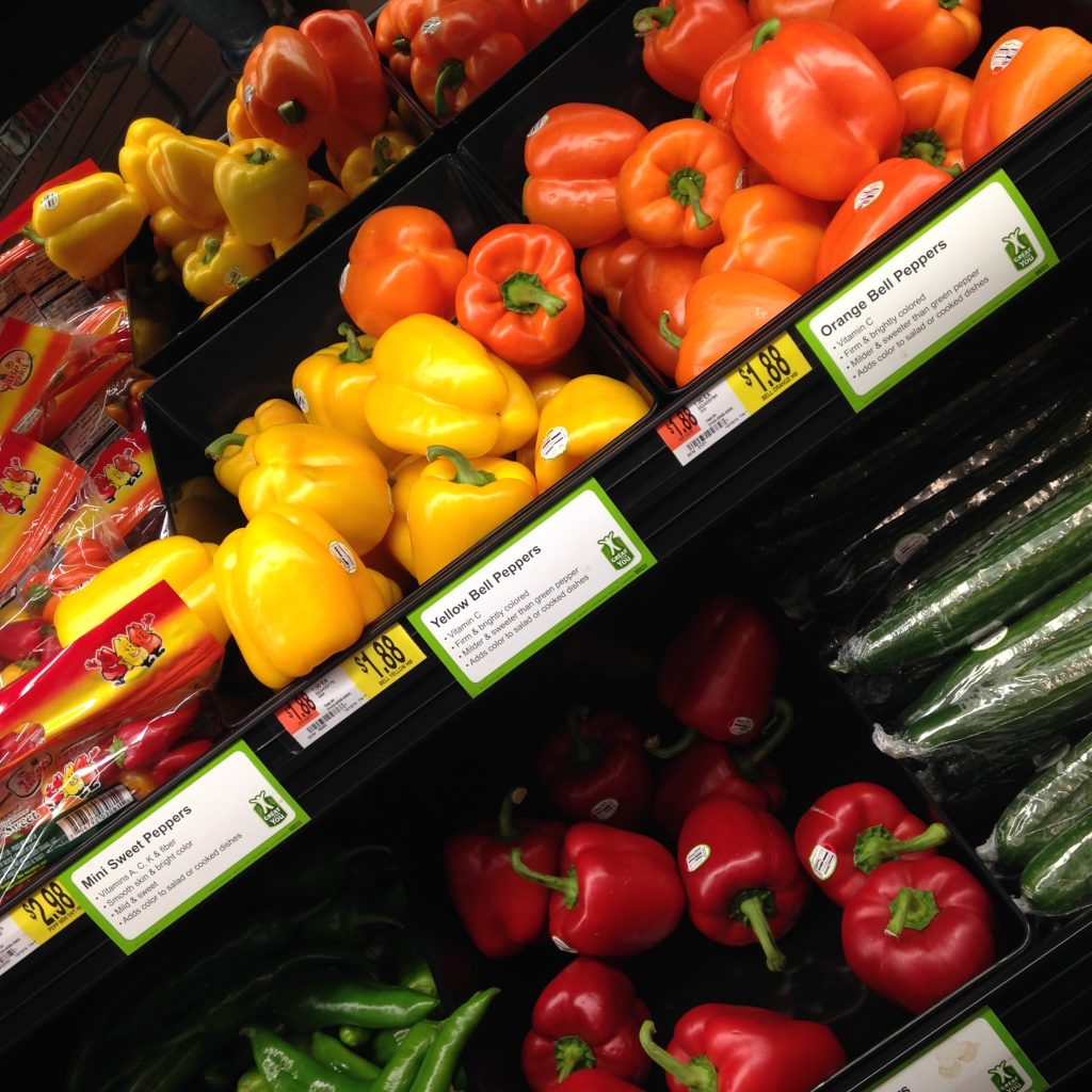 Fresh red and yellow bell peppers displayed in a market as part of growing sweet pepper production
