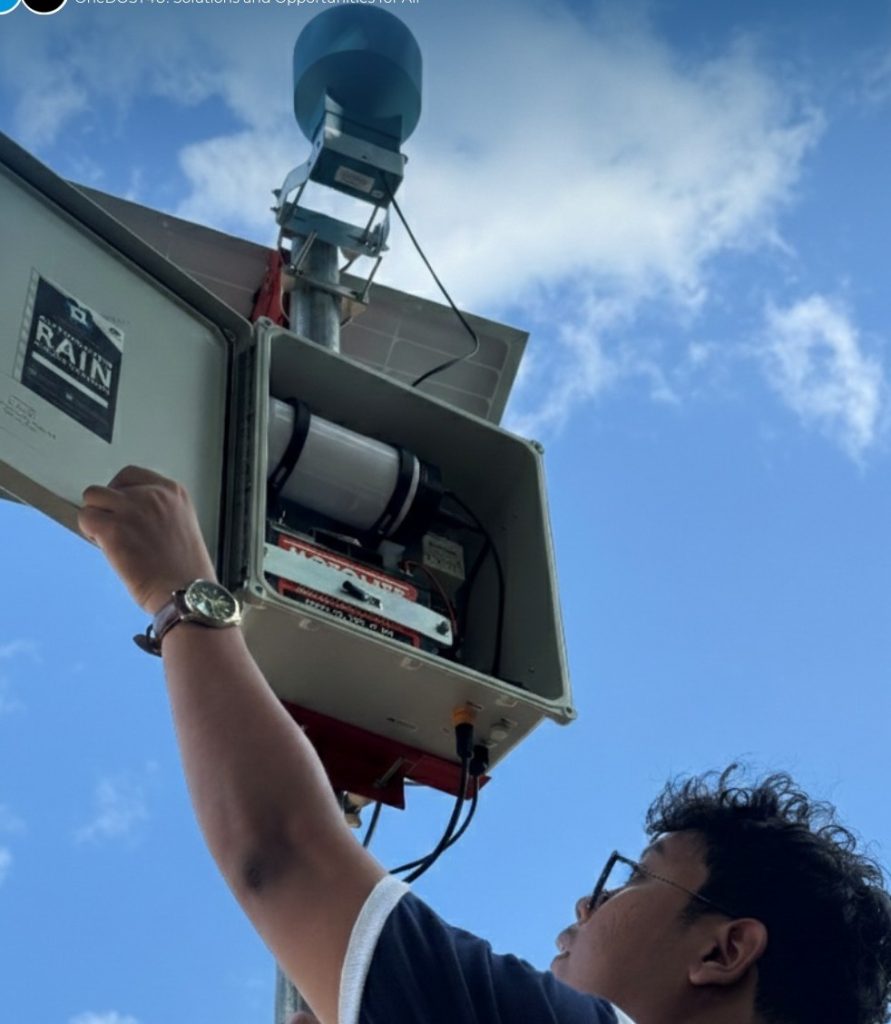 Technician installing DOST automated rain gauge to improve flood monitoring and disaster risk reduction in Sulop