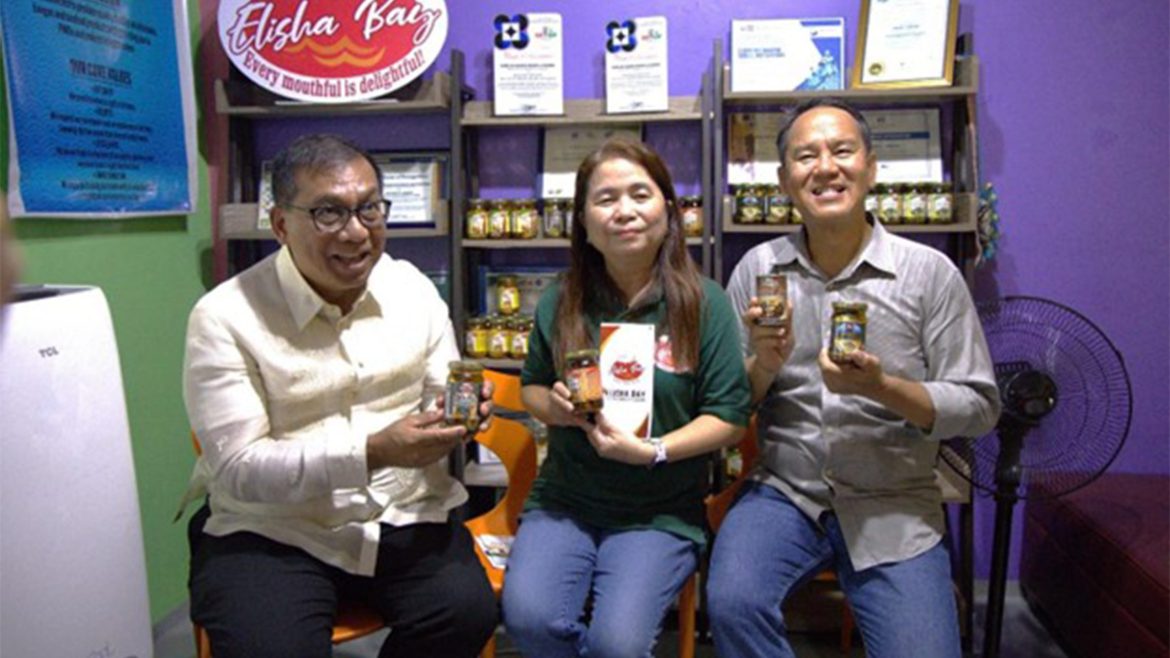 Owners of DOST SETUP Dagupan bangus enterprise holding processed bangus products
