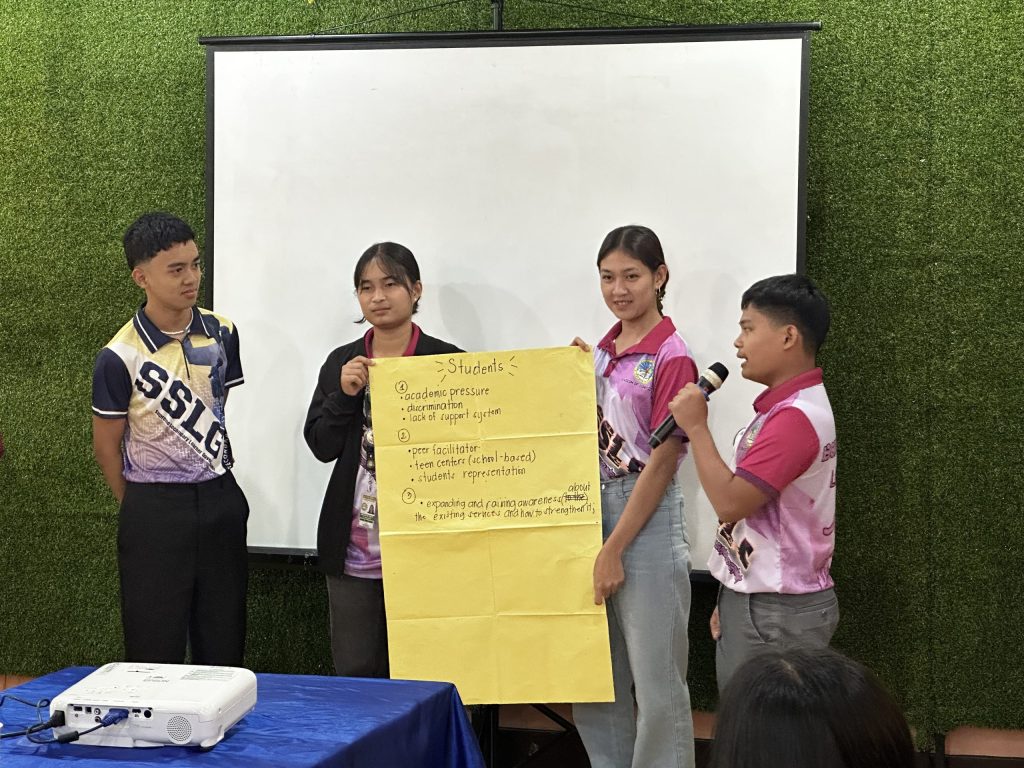 Students present group outputs during the IEC materials Ozamiz City workshop on mental health, ASRH, and disaster preparedness.