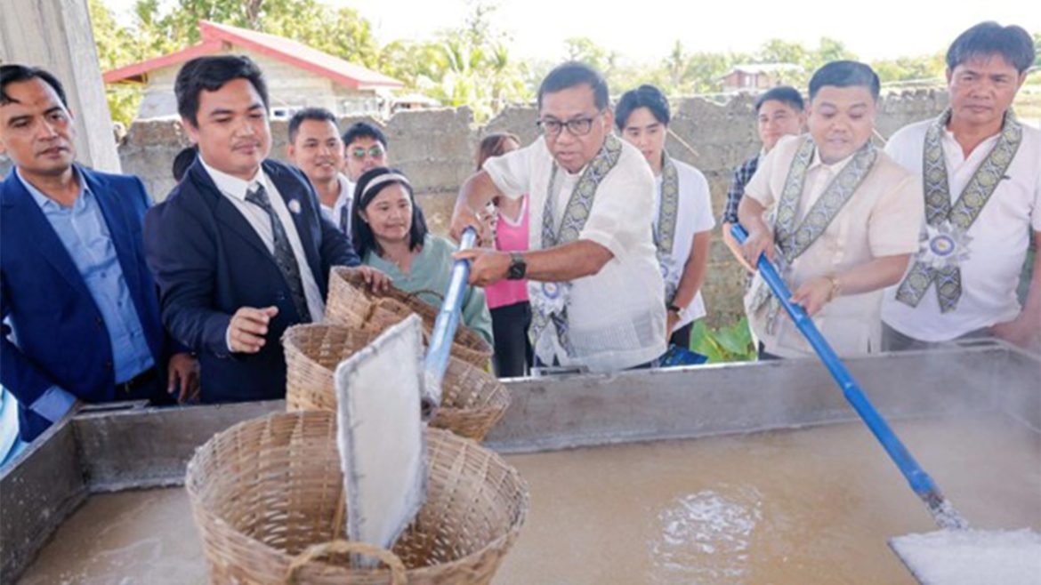 Officials demonstrating salt processing at the Pangasinan salt research center during inauguration