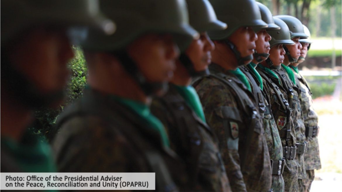 Philippine security forces stand in formation during a peacebuilding initiative highlighted in the PIDS peacebuilding study Philippines.