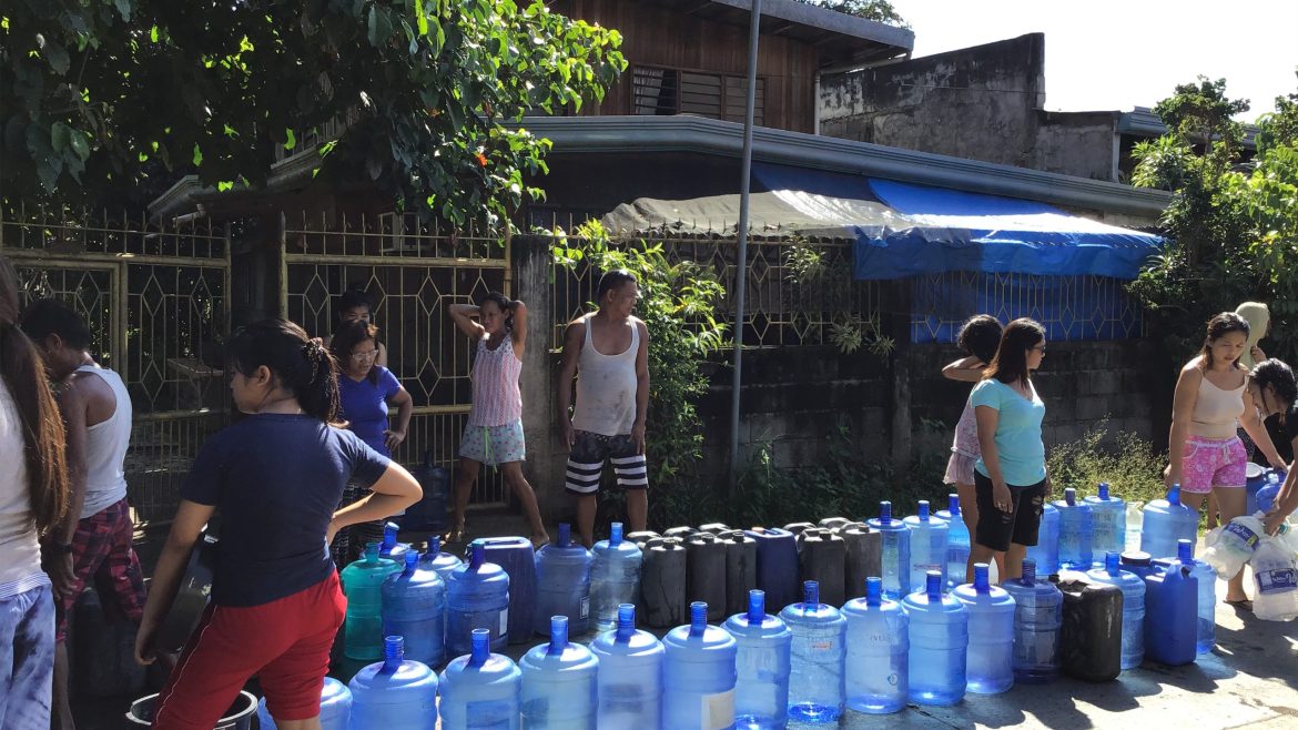 Residents lining up with water containers during a water supply shortage in the Philippines