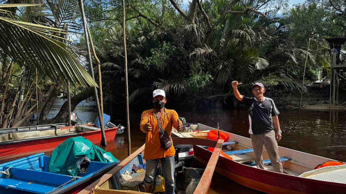 Wetlands conservation through cultural traditions as local community members navigate a river using traditional boats