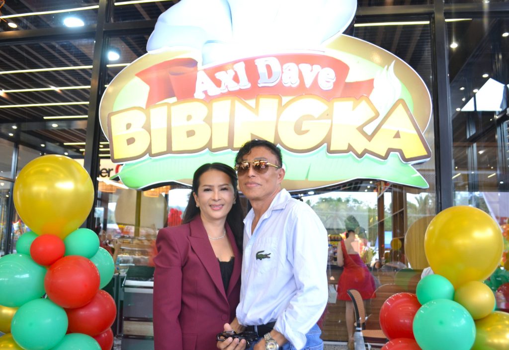 Guests pose in front of Axl Dave Bibingka Davao de Oro signage during the grand opening in Nabunturan.