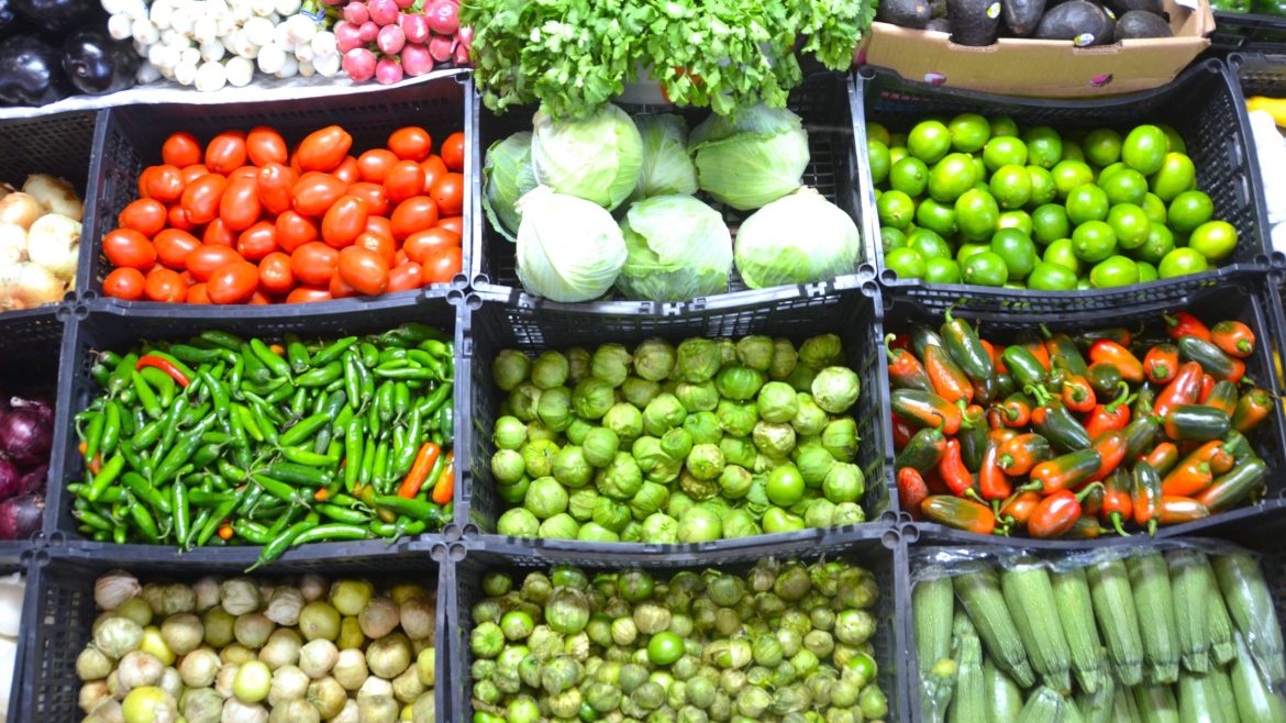 Various vegetables and crops displayed in a market representing agricultural diversity including biotech crops.