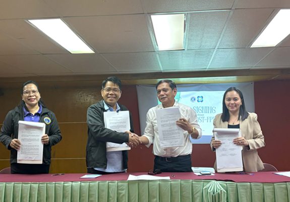 Officials from DOST-FPRDI and Bohol Island State University present documents during their partnership for heritage conservation in Bohol.