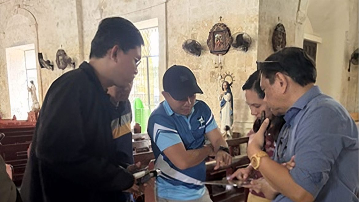 Researchers from DOST and Bohol Island State University examine wooden elements of a historic structure in Bohol.