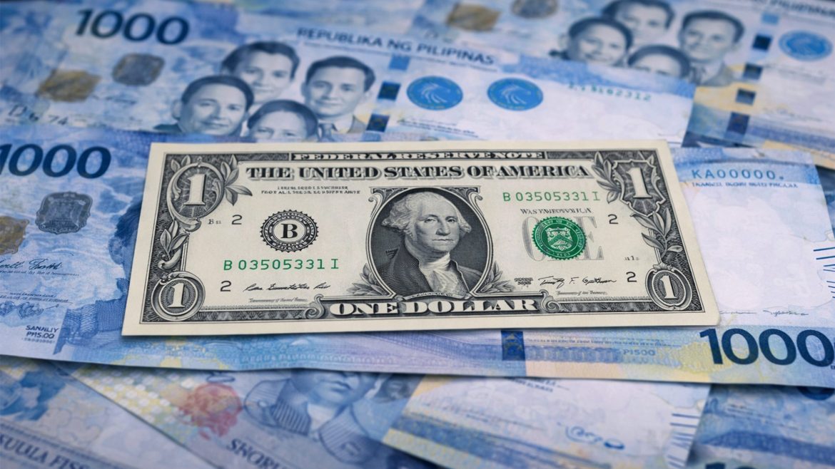 US one dollar bill placed over Philippine 1000 peso banknotes illustrating the peso to dollar exchange rate.