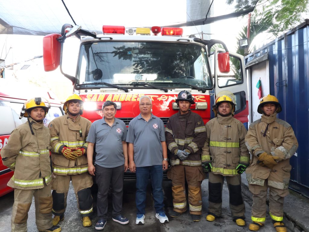 San Andres Fire Volunteers posing with fire truck and rescue equipment in Manila