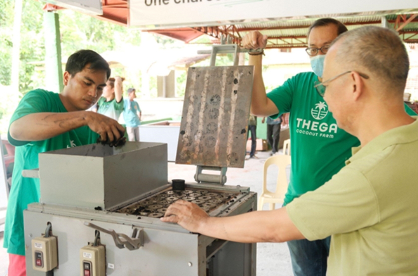 Workers operating bamboo processing machine for biomass fuel Philippines production