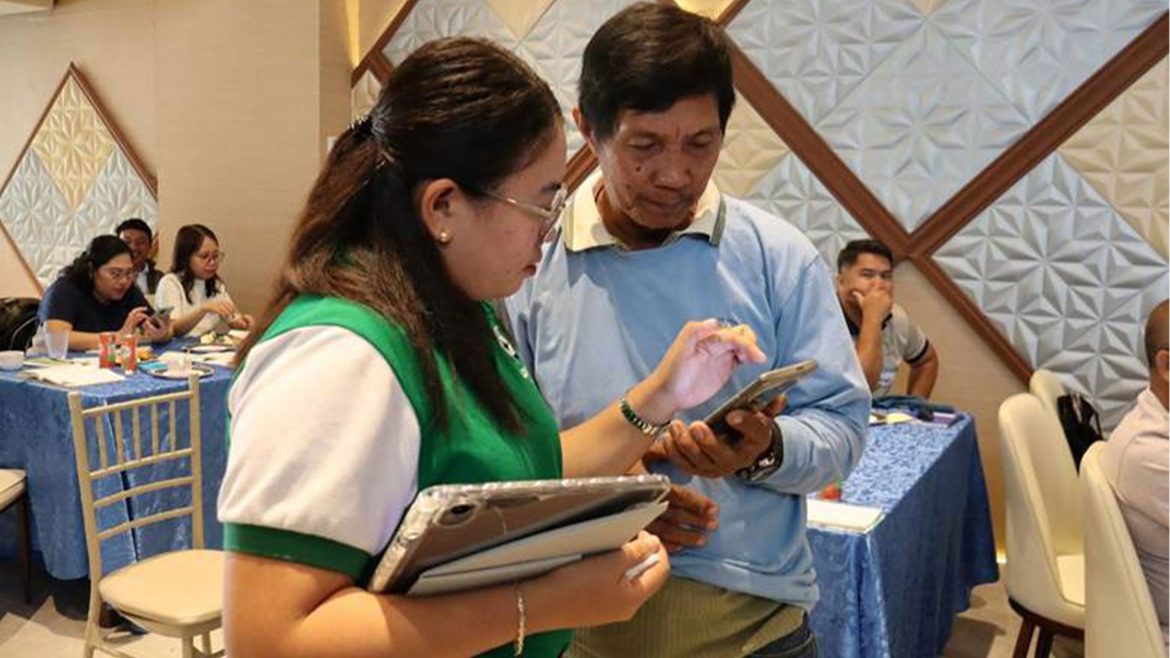 DOST personnel Engr Doreina L Lawangon demonstrates smart agriculture Philippines tools to farmers during training