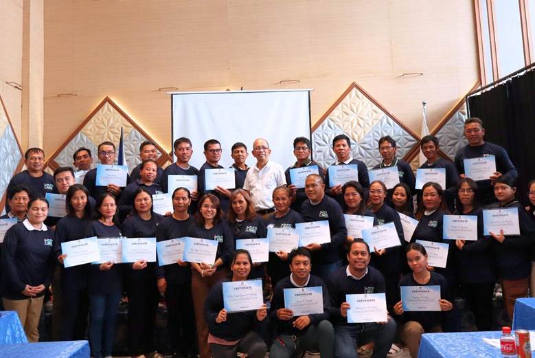 Farmers and extension workers pose after completing smart agriculture Philippines training in Caraga