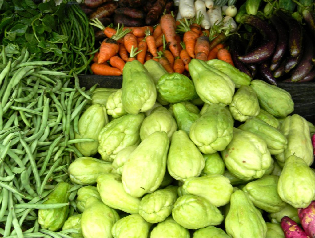 Fresh sayote vegetables displayed in a public market