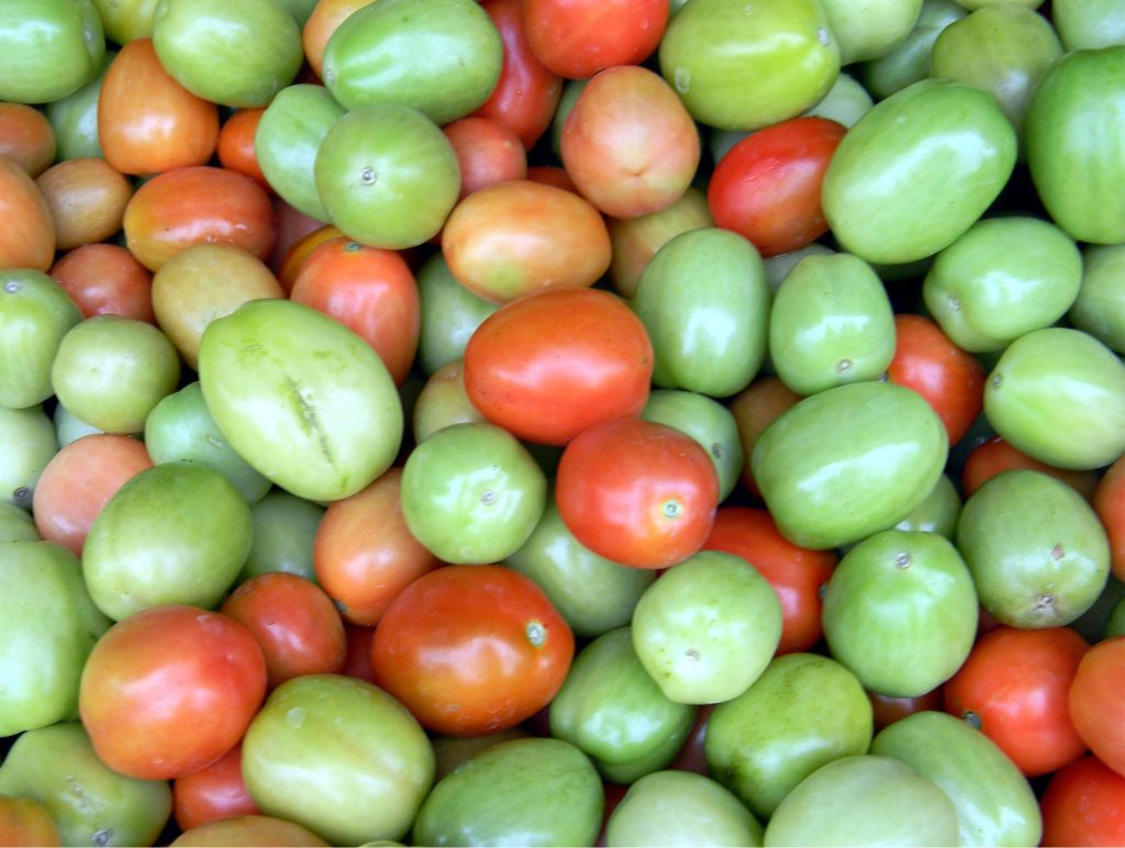 Fresh tomatoes displayed in a market as part of healing foods selection
