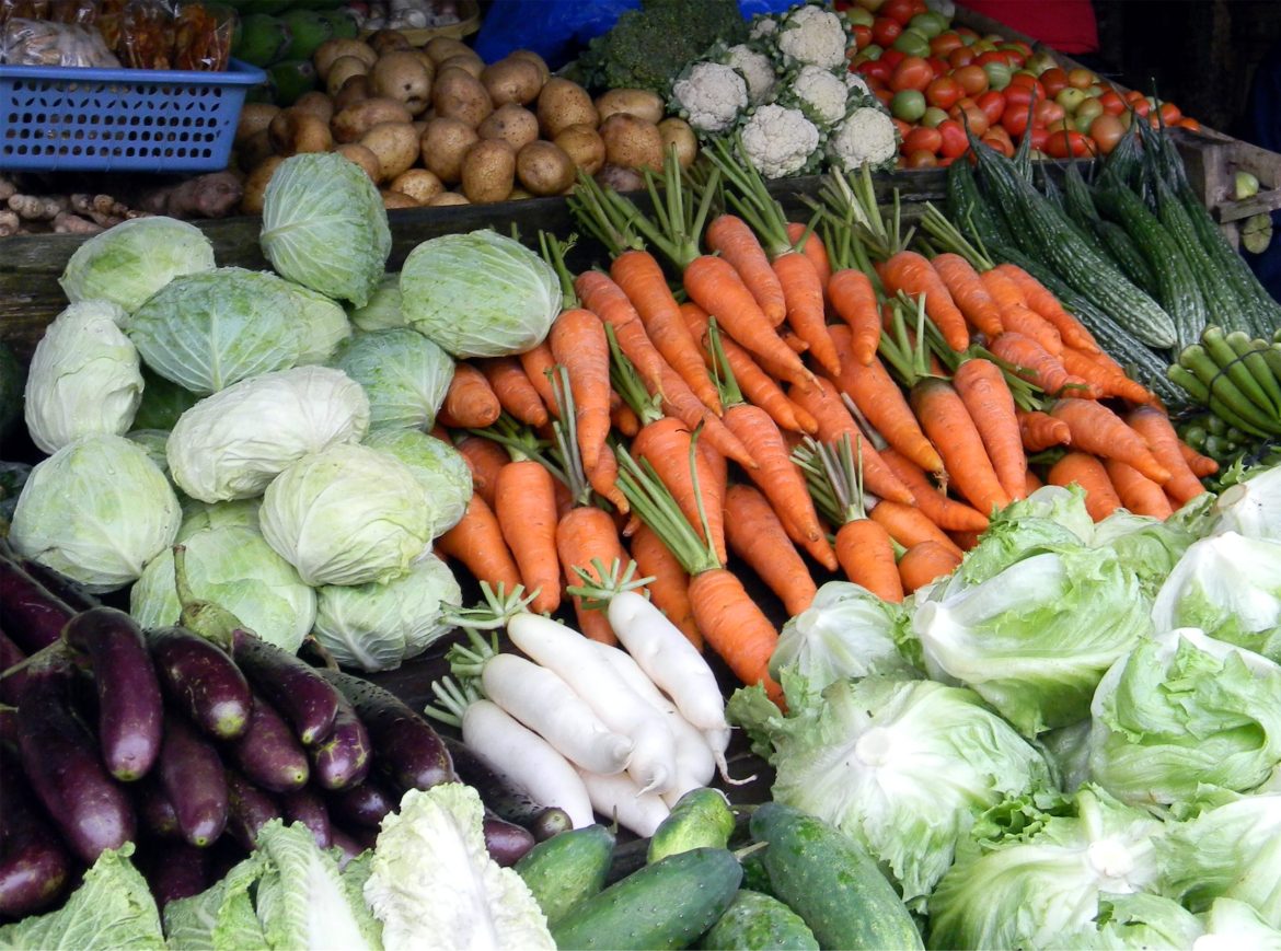 Assorted fresh vegetables displayed in a local market