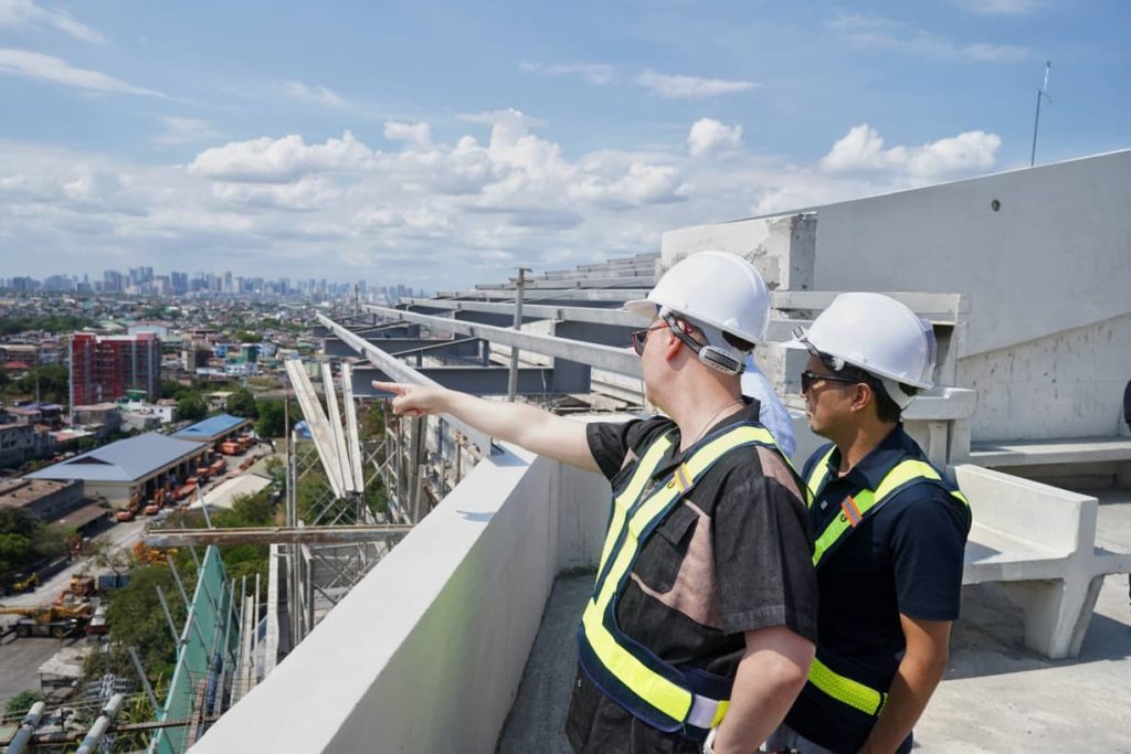 Construction officials survey the surrounding area from the upper level of the forensic laboratory project in Taguig.